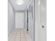Entryway with tile flooring, closet, white door and mirror at 1706 Belleair Forest Dr # 146, Belleair, FL 33756