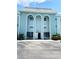 Inviting exterior of building with striking arches, well-maintained landscaping and accessible parking at 1706 Belleair Forest Dr # 146, Belleair, FL 33756