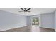 Living room featuring wood floors, a fan, and sliding glass doors to the patio at 1706 Belleair Forest Dr # 146, Belleair, FL 33756