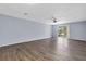 Living room featuring wood floors, a fan, and sliding glass doors to the patio at 1706 Belleair Forest Dr # 146, Belleair, FL 33756