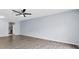 Spacious living room featuring wood floors, a fan, and an open layout at 1706 Belleair Forest Dr # 146, Belleair, FL 33756