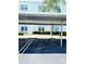 Assigned covered parking space number 186 in front of building with neatly manicured hedges at 1706 Belleair Forest Dr # 146, Belleair, FL 33756