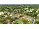 An aerial view showing a well-maintained community with ample parking and lush green spaces, set within a tranquil residential area at 1725 Pine Ridge E Way # E, Palm Harbor, FL 34684