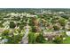 An aerial view of a quiet residential neighborhood with mature trees and well-maintained homes, near shopping and dining at 1725 Pine Ridge E Way # E, Palm Harbor, FL 34684