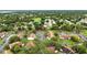 An aerial view showing a well-maintained community with ample parking and lush green spaces, set within a tranquil residential area at 1725 Pine Ridge E Way # E, Palm Harbor, FL 34684