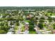 This aerial shows the property in a vibrant community, surrounded by lush greenery at 1725 Pine Ridge E Way # E, Palm Harbor, FL 34684