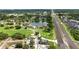 An elevated view of the property near a serene lake and convenient highway access at 1725 Pine Ridge E Way # E, Palm Harbor, FL 34684