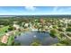 A tranquil community with a serene lake featuring a fountain, pool, and lush landscaping, close to a scenic golf course at 1725 Pine Ridge E Way # E, Palm Harbor, FL 34684