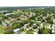 This aerial showcases a serene community with a lake, nestled among mature trees and lush greenery at 1725 Pine Ridge E Way # E, Palm Harbor, FL 34684