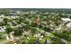 This is an aerial view showing a tranquil residential area with mature trees and green spaces at 1725 Pine Ridge E Way # E, Palm Harbor, FL 34684