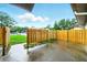 A view of the backyard which is surrounded by a wooden fence and a small section of lawn at 1725 Pine Ridge E Way # E, Palm Harbor, FL 34684