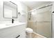 This bathroom is renovated with modern fixtures including the vanity, mirror, and shower stall at 1725 Pine Ridge E Way # E, Palm Harbor, FL 34684