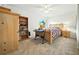Bright bedroom with neutral carpet, ceiling fan, and an expansive window for plenty of natural light at 1725 Pine Ridge E Way # E, Palm Harbor, FL 34684