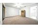 Spacious primary bedroom with carpet floors, neutral walls, and an ensuite bathroom with a shower at 1725 Pine Ridge E Way # E, Palm Harbor, FL 34684