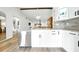 Updated kitchen featuring stainless steel appliances, white cabinets, a granite countertop and modern finishes at 1725 Pine Ridge E Way # E, Palm Harbor, FL 34684