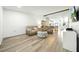 Bright living room featuring hardwood floors, cozy seating, and open layout to kitchen at 1725 Pine Ridge E Way # E, Palm Harbor, FL 34684