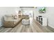 Inviting living room with hardwood floors, comfortable seating, and modern entertainment center at 1725 Pine Ridge E Way # E, Palm Harbor, FL 34684