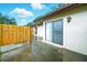 Enclosed patio with access to the main house, featuring sliding glass door and updated lighting at 1725 Pine Ridge E Way # E, Palm Harbor, FL 34684