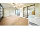 The sunroom has carpet and sliding door access to the home's living spaces at 1725 Pine Ridge E Way # E, Palm Harbor, FL 34684