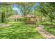 Backyard view features a charming gazebo and a well-maintained lawn at 18110 30Th St, Lutz, FL 33559