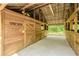 View of the rustic barn's interior showcasing wooden stalls, metal roof, and open space for animals at 18110 30Th St, Lutz, FL 33559