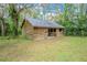 Exterior view of the rustic wooden barn, including an open stall and fenced paddock at 18110 30Th St, Lutz, FL 33559
