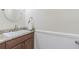 Charming half-bathroom featuring a vanity with granite countertop, sink, and decorative accents at 18110 30Th St, Lutz, FL 33559