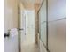 Bathroom with neutral tiling, a shower, and seamless glass doors at 18110 30Th St, Lutz, FL 33559
