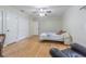 Spacious bedroom featuring hardwood floors, a ceiling fan, and ample closet space at 18110 30Th St, Lutz, FL 33559
