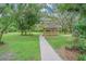 A picturesque gazebo is nestled amidst lush greenery, offering a tranquil retreat on the expansive lawn at 18110 30Th St, Lutz, FL 33559