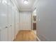 The home's hallway has ample storage, hardwood flooring, and neutral colors with a view of the bathroom at 18110 30Th St, Lutz, FL 33559