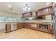 Stylish kitchen with custom cabinets, granite countertops, stainless steel appliances, and hardwood floors at 18110 30Th St, Lutz, FL 33559