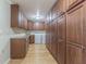 A large laundry room with abundant storage cabinets, granite countertop, a utility sink, and an included washer and dryer at 18110 30Th St, Lutz, FL 33559