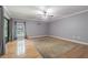 The living room boasts hardwood floors, a neutral gray wall color and large window allowing for plenty of natural light at 18110 30Th St, Lutz, FL 33559