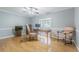Bright home office with hardwood floors, ceiling fan, and large window providing ample natural light at 18110 30Th St, Lutz, FL 33559