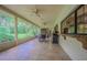 Screened patio with tile flooring, ceiling fans, and an outdoor kitchen perfect for entertaining at 18110 30Th St, Lutz, FL 33559