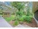 A verdant landscape showcases a charming gazebo, complemented by well-maintained flowerbeds and trees at 18110 30Th St, Lutz, FL 33559