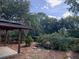 Landscaped backyard featuring a wooden pergola-covered patio with lush planting at 1861 Harmony Dr, Clearwater, FL 33756