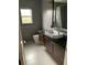 Modern bathroom with sleek vanity, dark countertop, and stylish fixtures at 1861 Harmony Dr, Clearwater, FL 33756