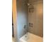 Bathroom shower featuring gray tiling and built-in shelving niche at 1861 Harmony Dr, Clearwater, FL 33756