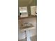 Bathroom vanity with a classic white pedestal sink and large mirror at 1861 Harmony Dr, Clearwater, FL 33756