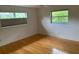 Clean and bright bedroom with hardwood floors and large windows for natural light at 1861 Harmony Dr, Clearwater, FL 33756