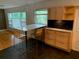 Stylish kitchen featuring an island with bar seating, modern cabinets, and views of the backyard at 1861 Harmony Dr, Clearwater, FL 33756