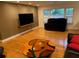 Spacious living room with hardwood floors, comfortable seating, and ample natural light at 1861 Harmony Dr, Clearwater, FL 33756