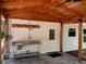 Covered patio with stainless steel sink and overhead lighting fixture at 1861 Harmony Dr, Clearwater, FL 33756