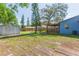 Wide backyard view with a shed, storage unit, and covered deck at 1912 E 97Th Ave, Tampa, FL 33612