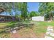 Spacious backyard with mature trees, a deck, and a storage shed at 1912 E 97Th Ave, Tampa, FL 33612