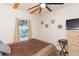 Cozy bedroom with neutral paint, exposed wood beams, and large window at 1912 E 97Th Ave, Tampa, FL 33612