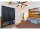 The primary bedroom features exposed beams and a full closet at 1912 E 97Th Ave, Tampa, FL 33612