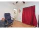 Spacious bedroom featuring wood floors, closet space, and a comfortable chair at 1912 E 97Th Ave, Tampa, FL 33612